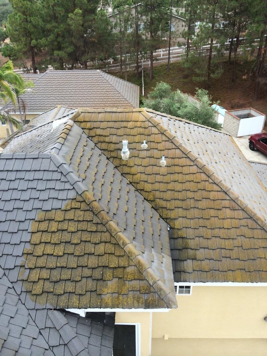 Flat Tile Roof During Cleaning by Washed Out Pressure Washing
